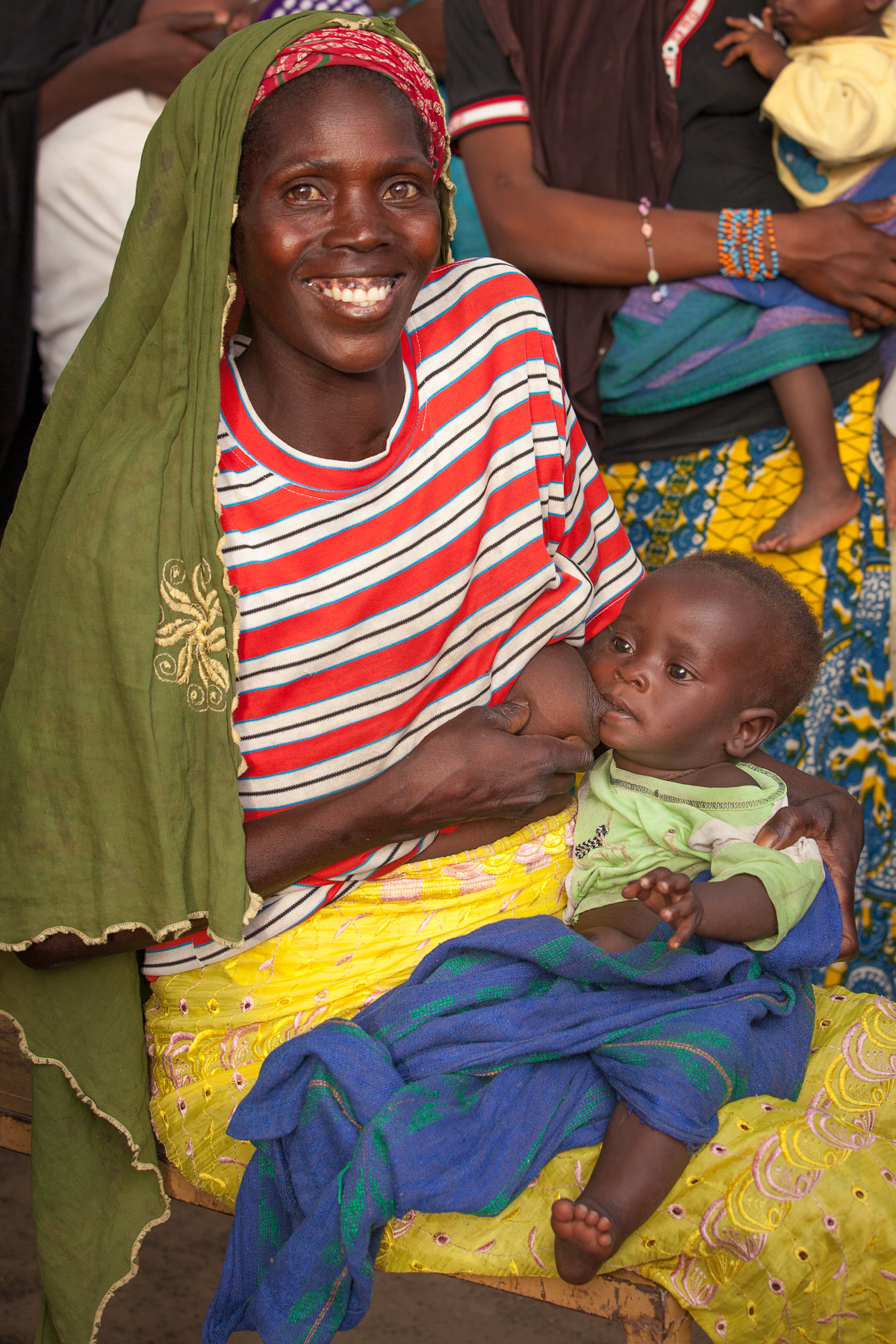 Village of Abaza, South of Fada, May 6, 2014: A village volunteer farmer breast feeding her baby.